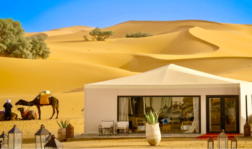 Golden hour in the Sahara Desert with red and orange hues 